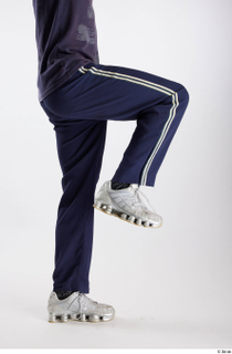 Urien  1 blue track pants dressed flexing leg side…